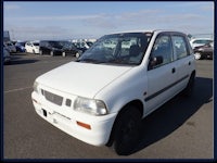 a white car is parked in a parking lot