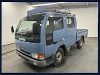 a blue truck is parked in a garage