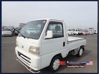 a white pickup truck is parked in a parking lot