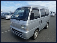 a silver van is parked in a parking lot